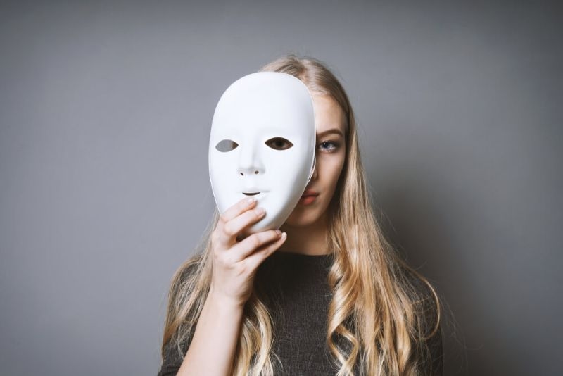woman holding white mask