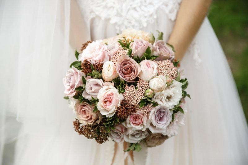 bride is holding a wedding bouquet