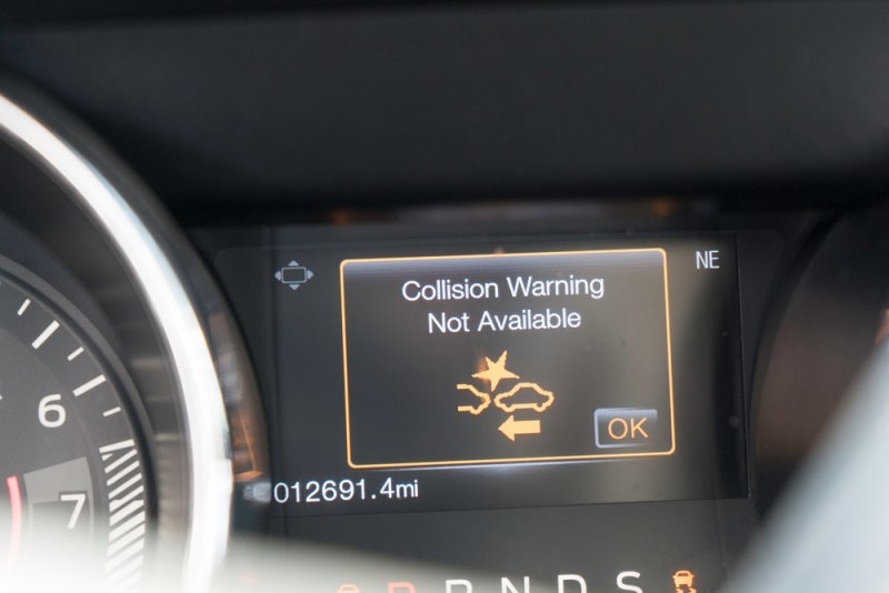 Car's dashboard showing collision warning not available on screen