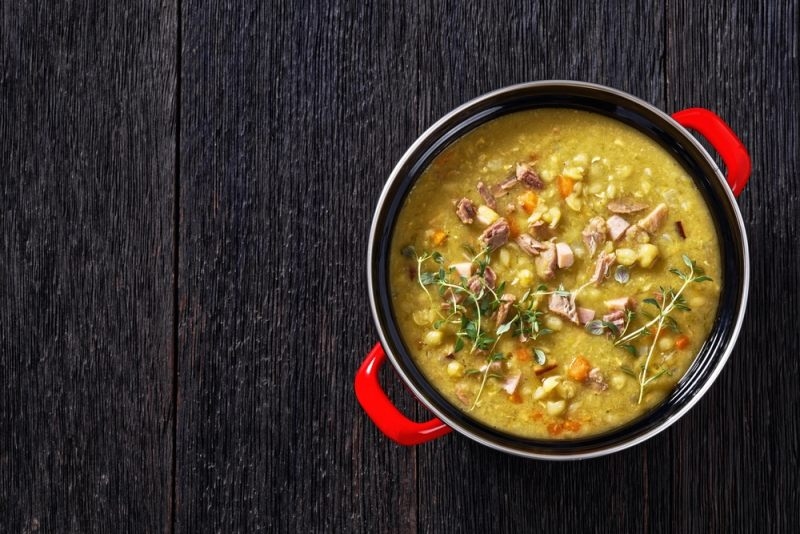 Homemade Finnish pea soup featuring split peas, diced ham, and fresh herbs