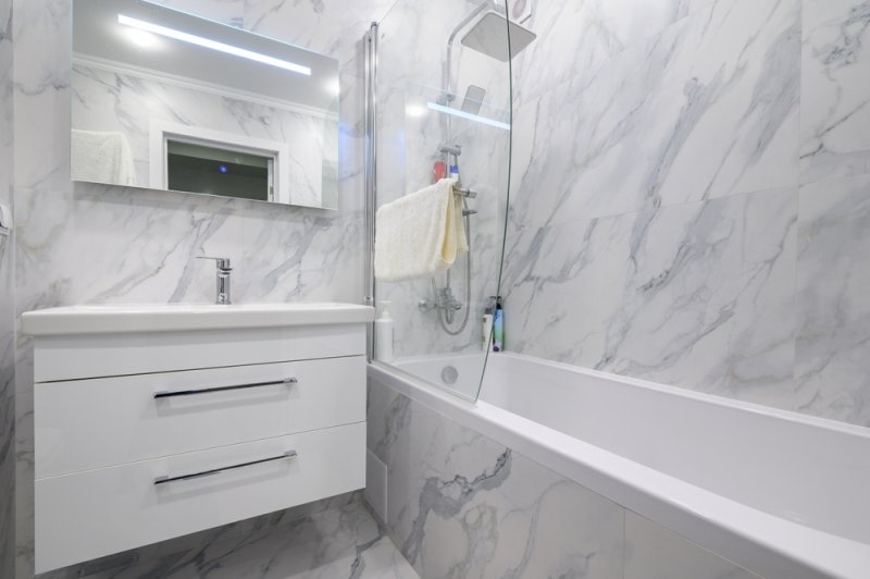 Modern white marble bathroom interior with cabinet