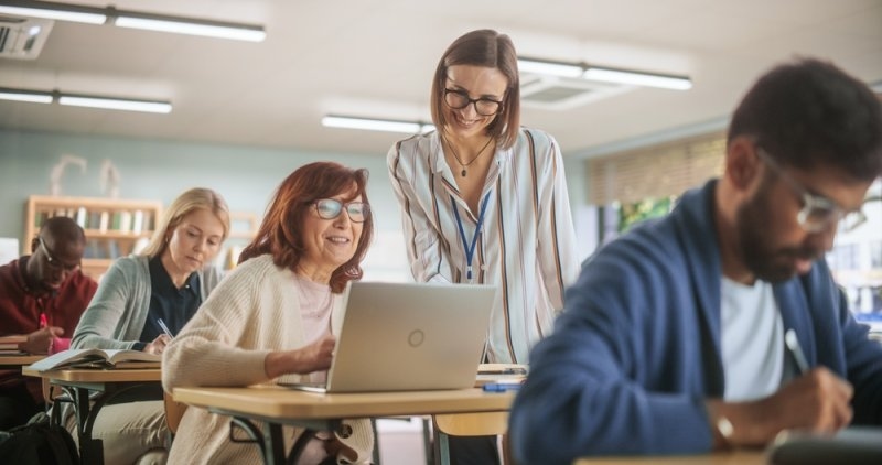 Young Teacher helping a senior women understand a lesson