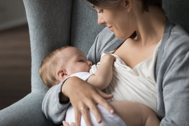 woman breastfeeding her child in cradle position