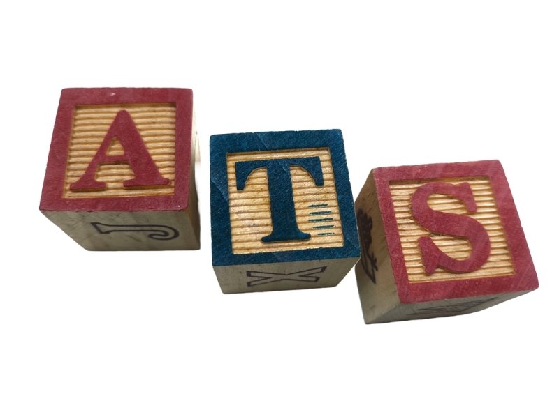 Text ATS printed on wooden blocks symbolizing Applicant Tracking System 