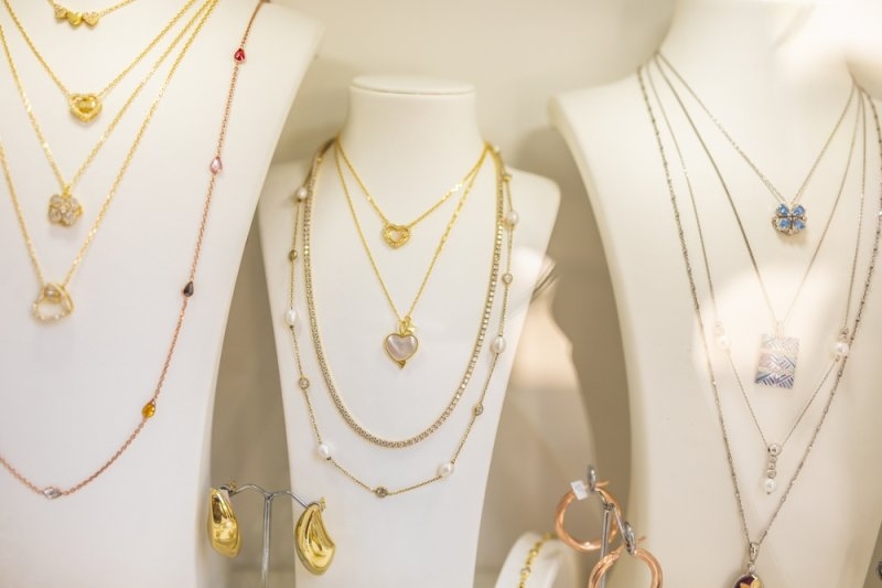 minimal layered necklaces with heart pendants on display