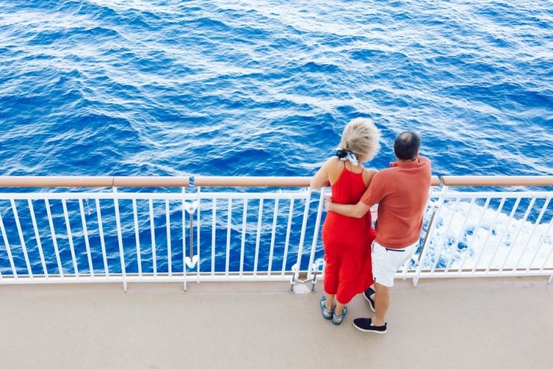couples standing on the deck of a cruise ship