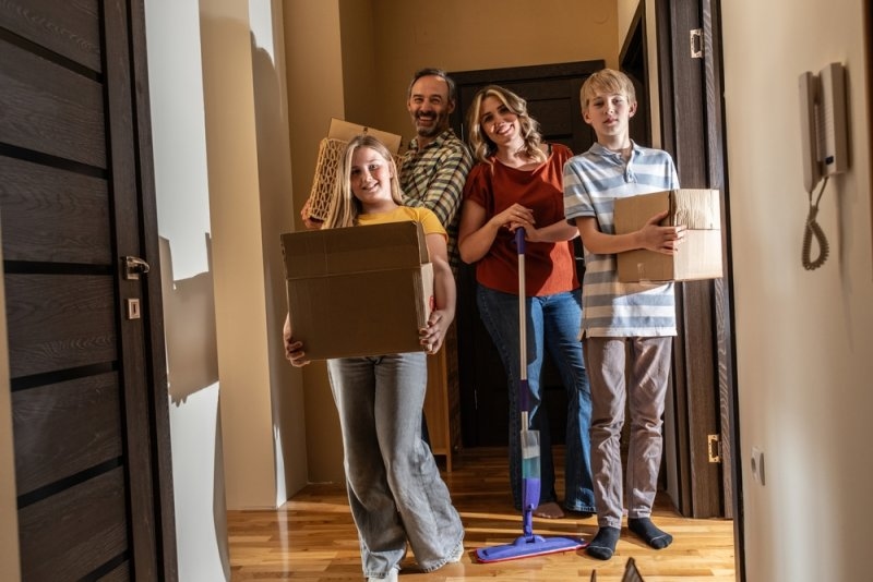 family members unpacking boxes and moving into their new home