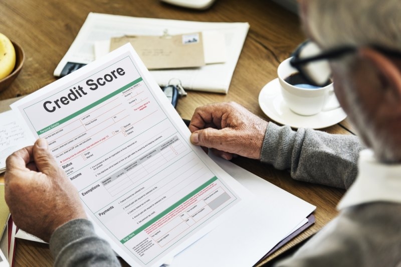 Man reading credit score papers