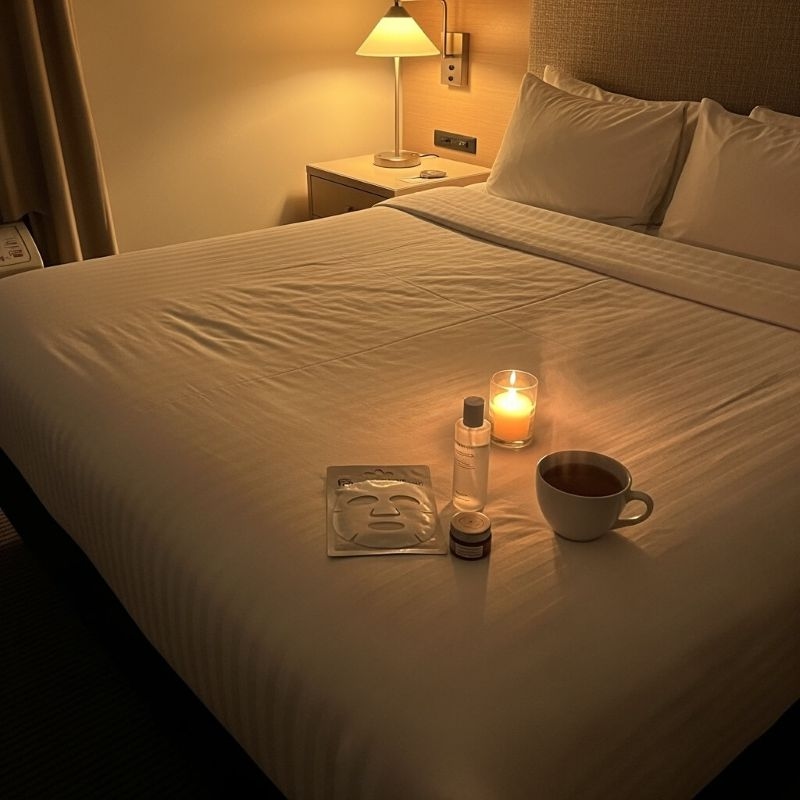 night skincare essentials on bed