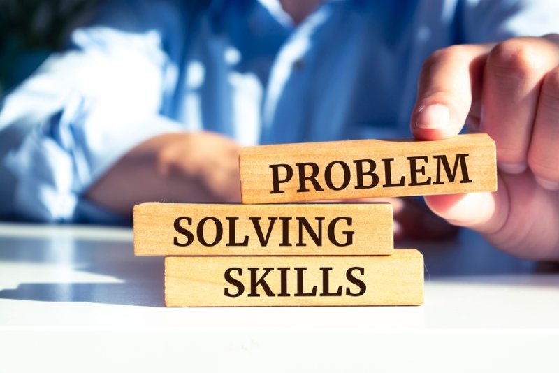 text Problem Solving Skills printed on three wooden blocks 
