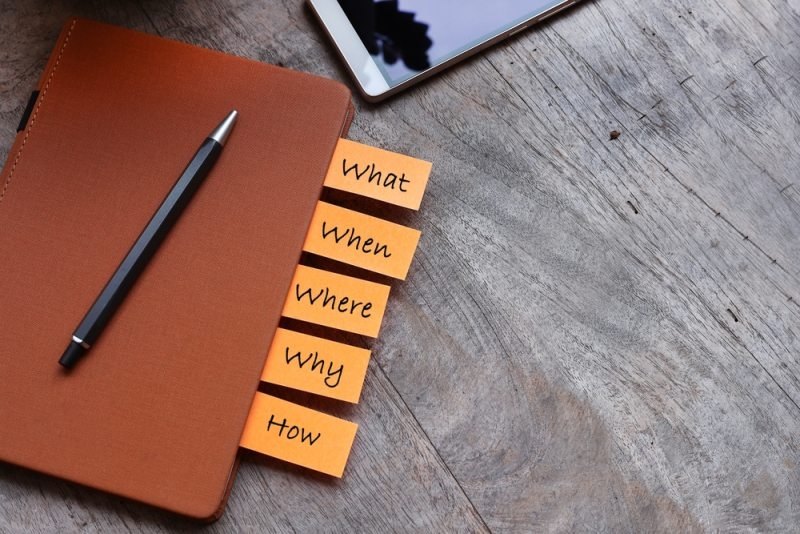 2. A close-up shot of a notebook with vibrant yellow sticky tabs arranged on the edges