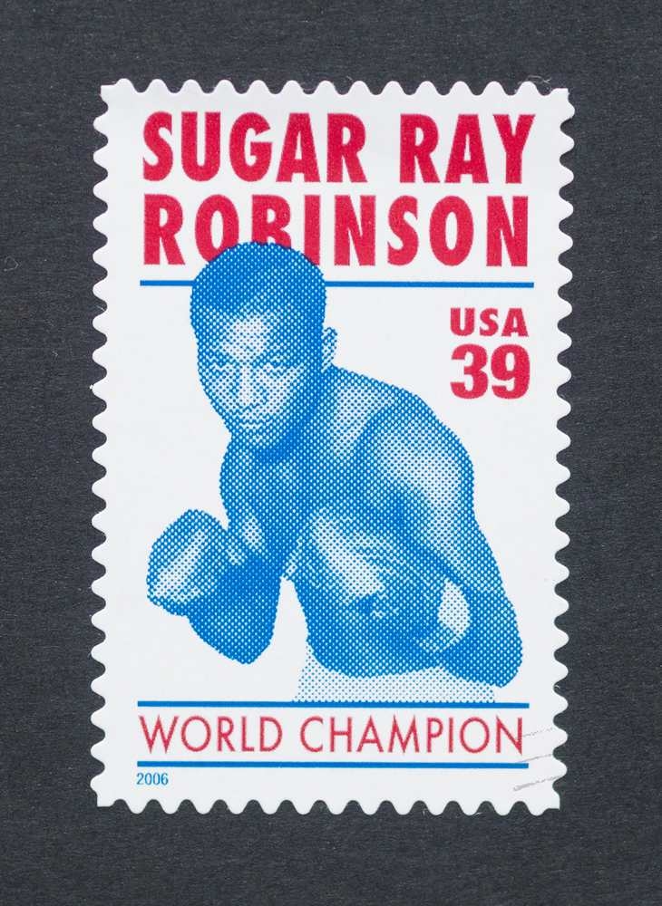 Commemorative postage stamp featuring boxer Sugar Ray Robinson with text identifying him as a world champion.
