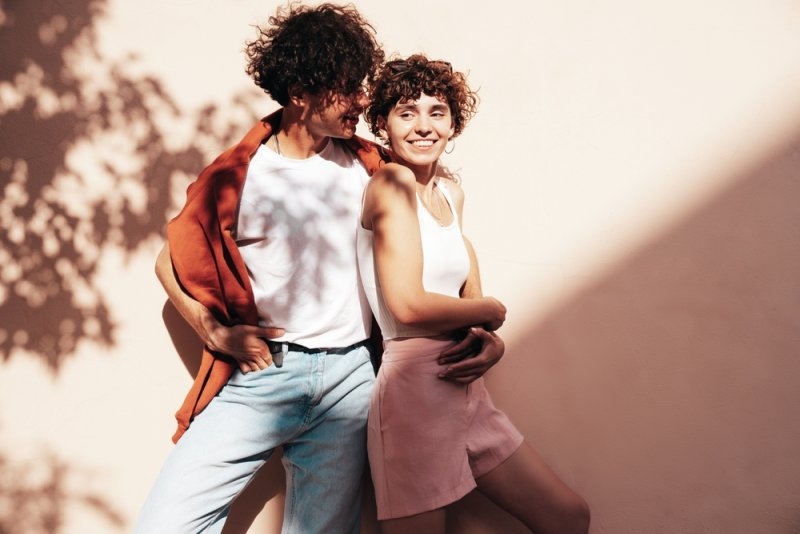 young couple wearing summer clothing and posing