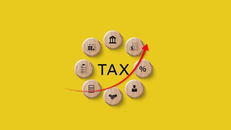 tax essential heads on wooden blocks