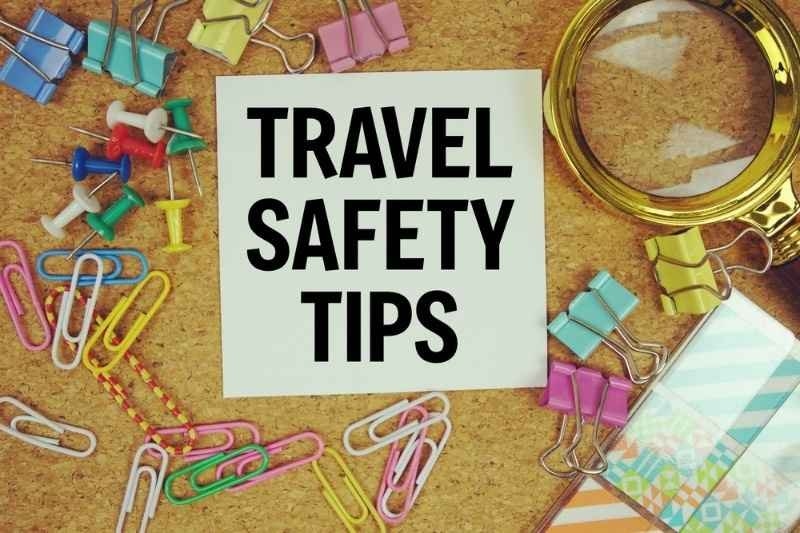 A corkboard displays “TRAVEL SAFETY TIPS” surrounded by travel-themed stationery and a magnifying glass.