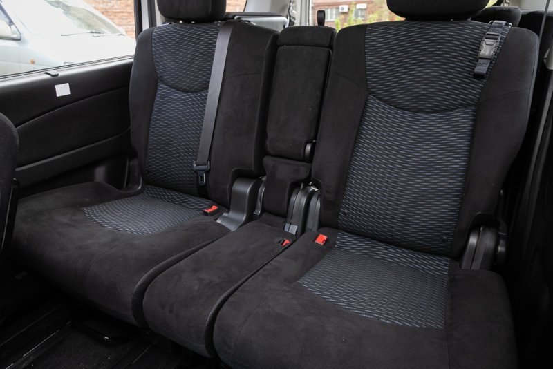 Toyota Sienna second-row seats showing individual seating space, armrests, and seat belts.