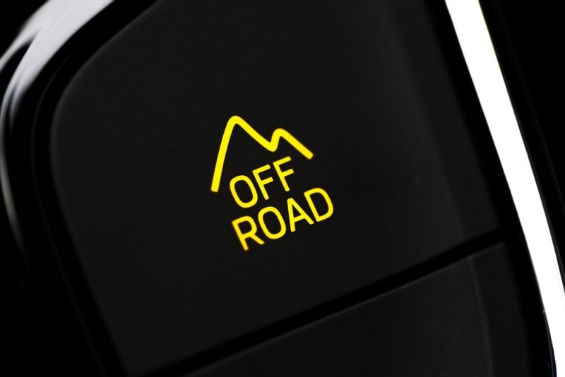 A close-up of a vehicle dashboard displaying a yellow