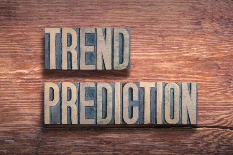 Wooden letterpress blocks spelling ‘Trend Prediction’ on a rustic wooden surface.