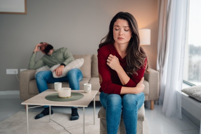 Woman and man experiencing an emotional conflict and stress at home. Focusing on frustration and relationship struggle
