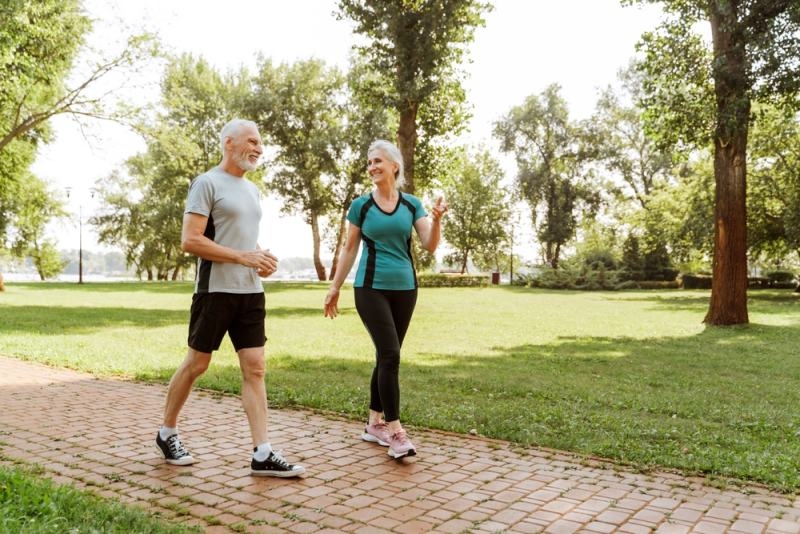 elderly couple walking in the park