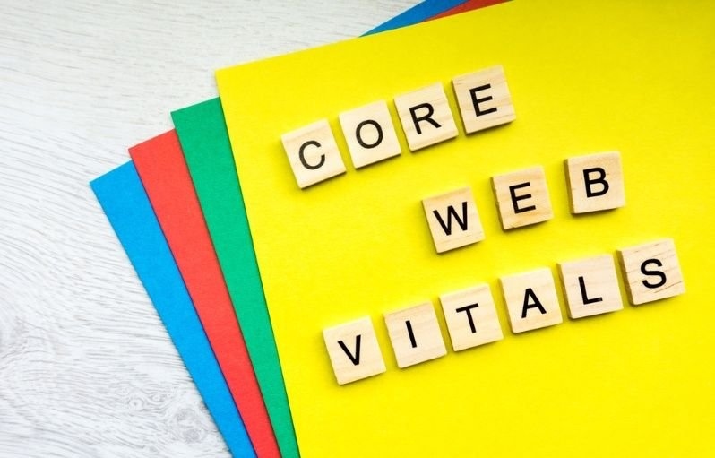 Wooden letter tiles spelling "Core Web Vitals" on colorful paper backgrounds.