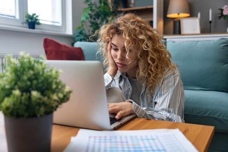 woman feeling depressed while working on youtube