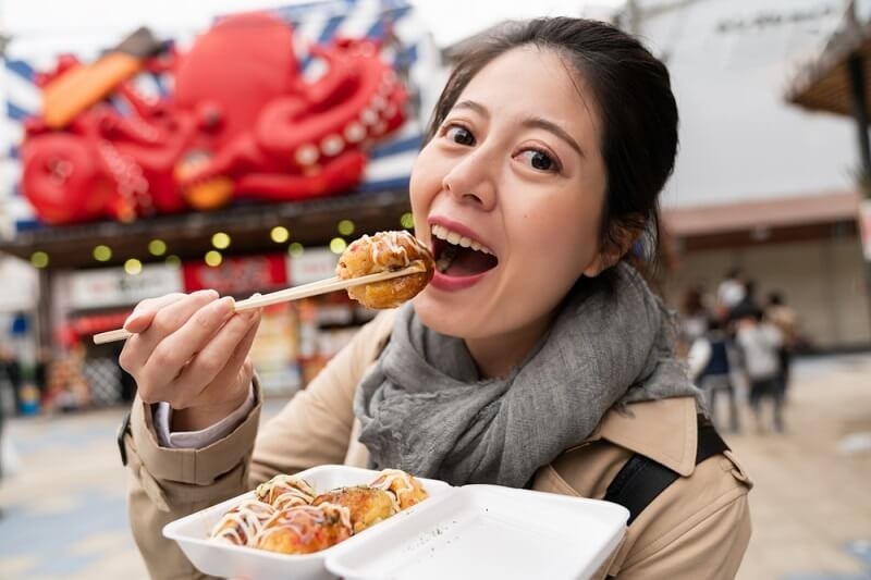 woman eating street food on her solo trip