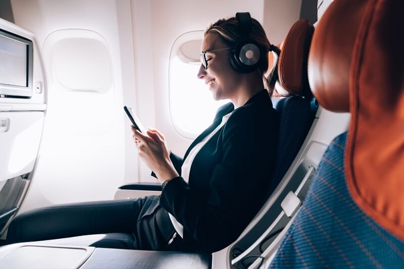 woman in flight looking at phone