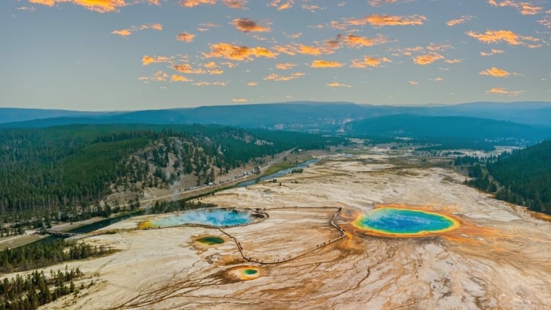 Aerial view of Yellowstone’s colorful geothermal pools and surrounding landscape.