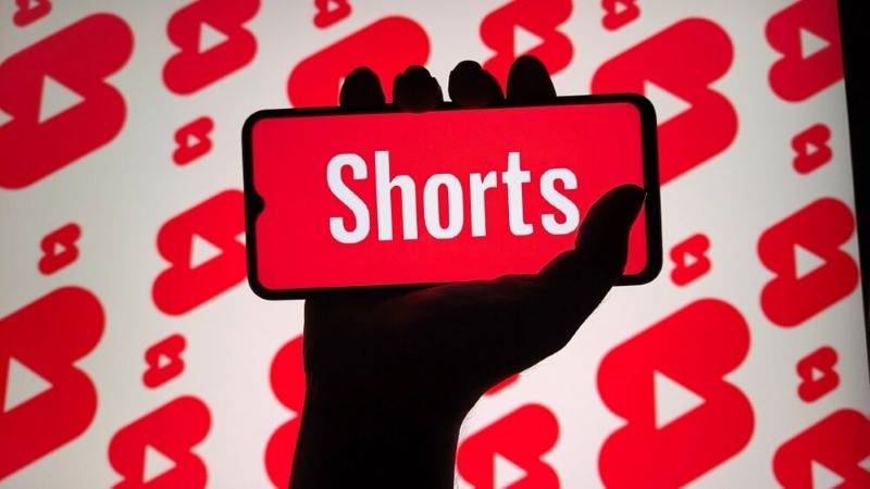 you tube shorts on a mobile screen with phone in hand